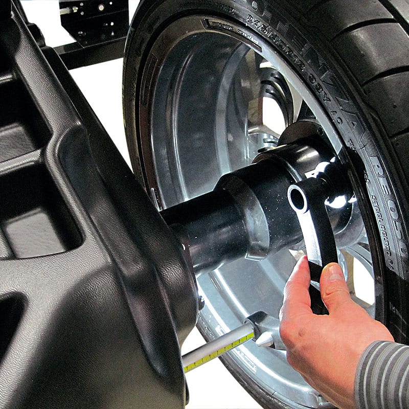 Rotary® Wheel Balancer – R148 | Pro Shop 2D Technician adjusting wheel on Rotary R148 Pro Shop 2D Wheel Balancer